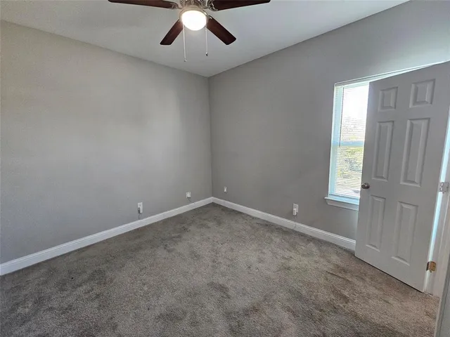 an empty room with a empty space and a ceiling fan