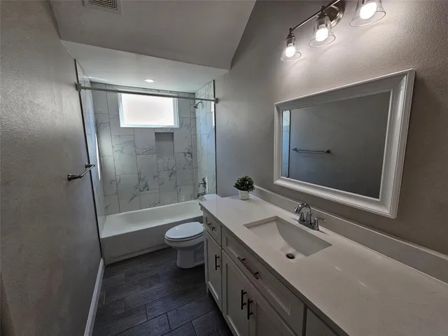 a bathroom with a double vanity sink mirror and toilet