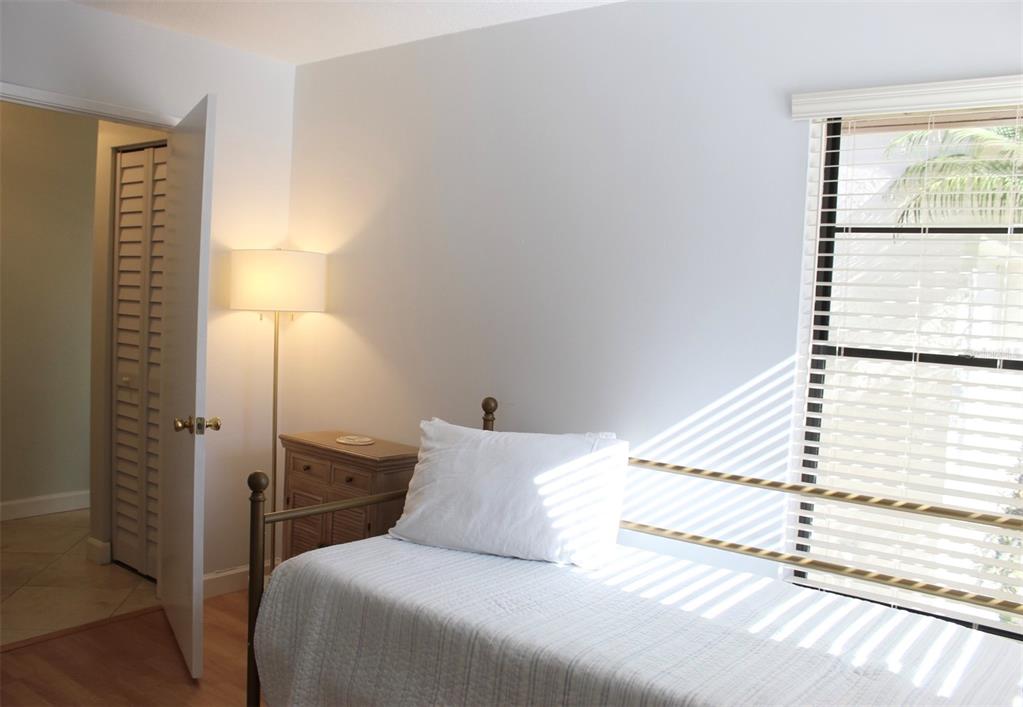 22383 Thousand Pines Lane Boca Raton, FL 33428 - Photo 16 of 28 a bedroom with a bed and a night stand