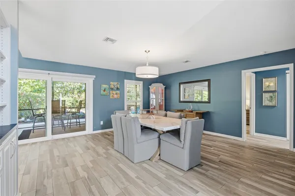 a dining room with furniture and wooden floor