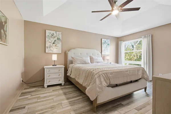 a bedroom with a bed and a chandelier