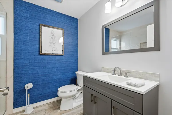 a view of a living room with furniture and floor to ceiling windows