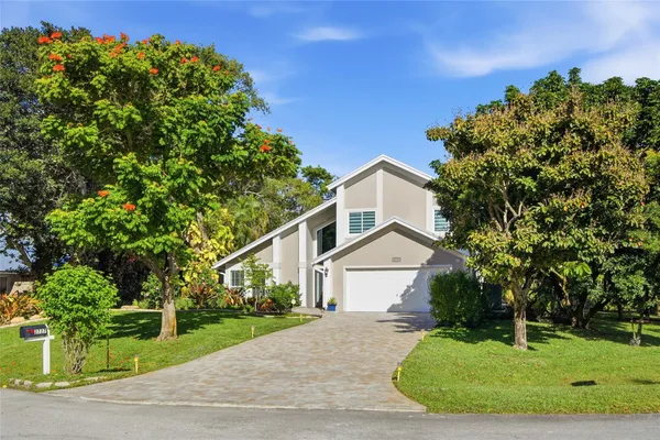 an aerial view of a house with a yard and garden