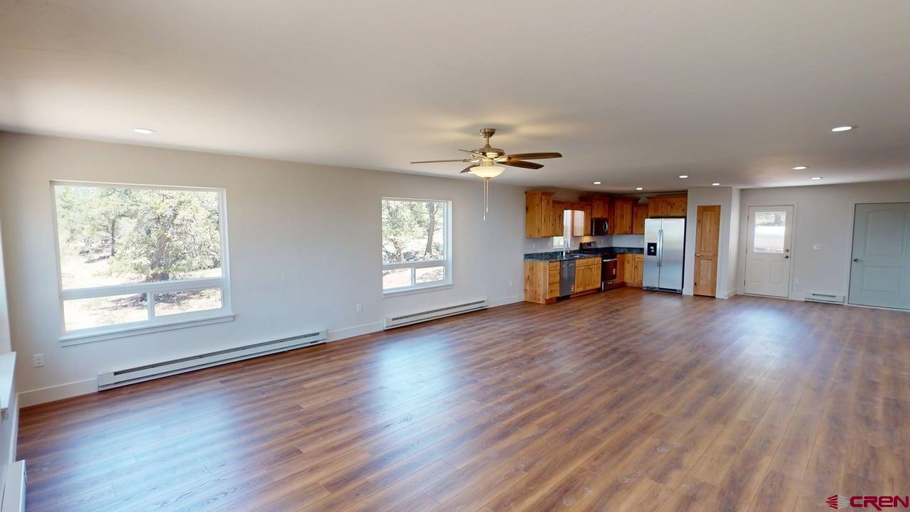 216 Baca Grant Way Crestone, CO 81131 - Photo 4 of 17 wooden floor in an empty room with a window