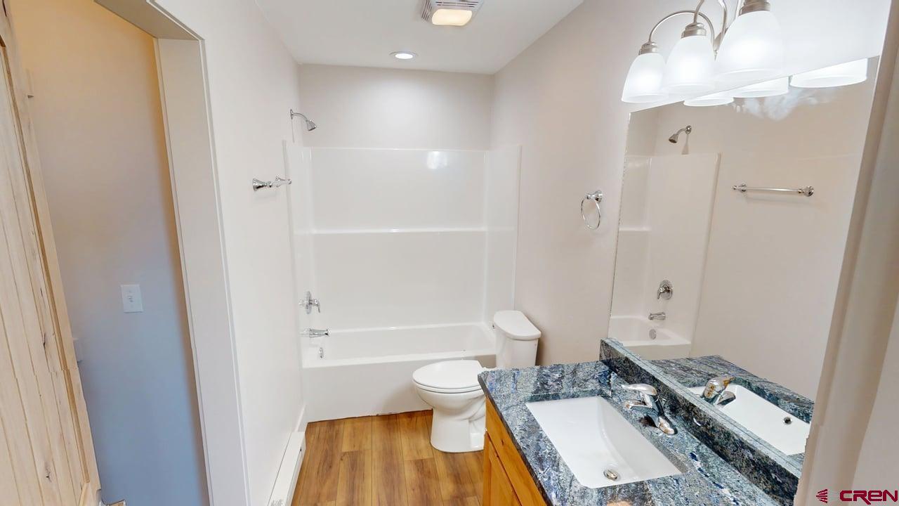 216 Baca Grant Way Crestone, CO 81131 - Photo 8 of 17 a bathroom with a sink a toilet and a large mirror