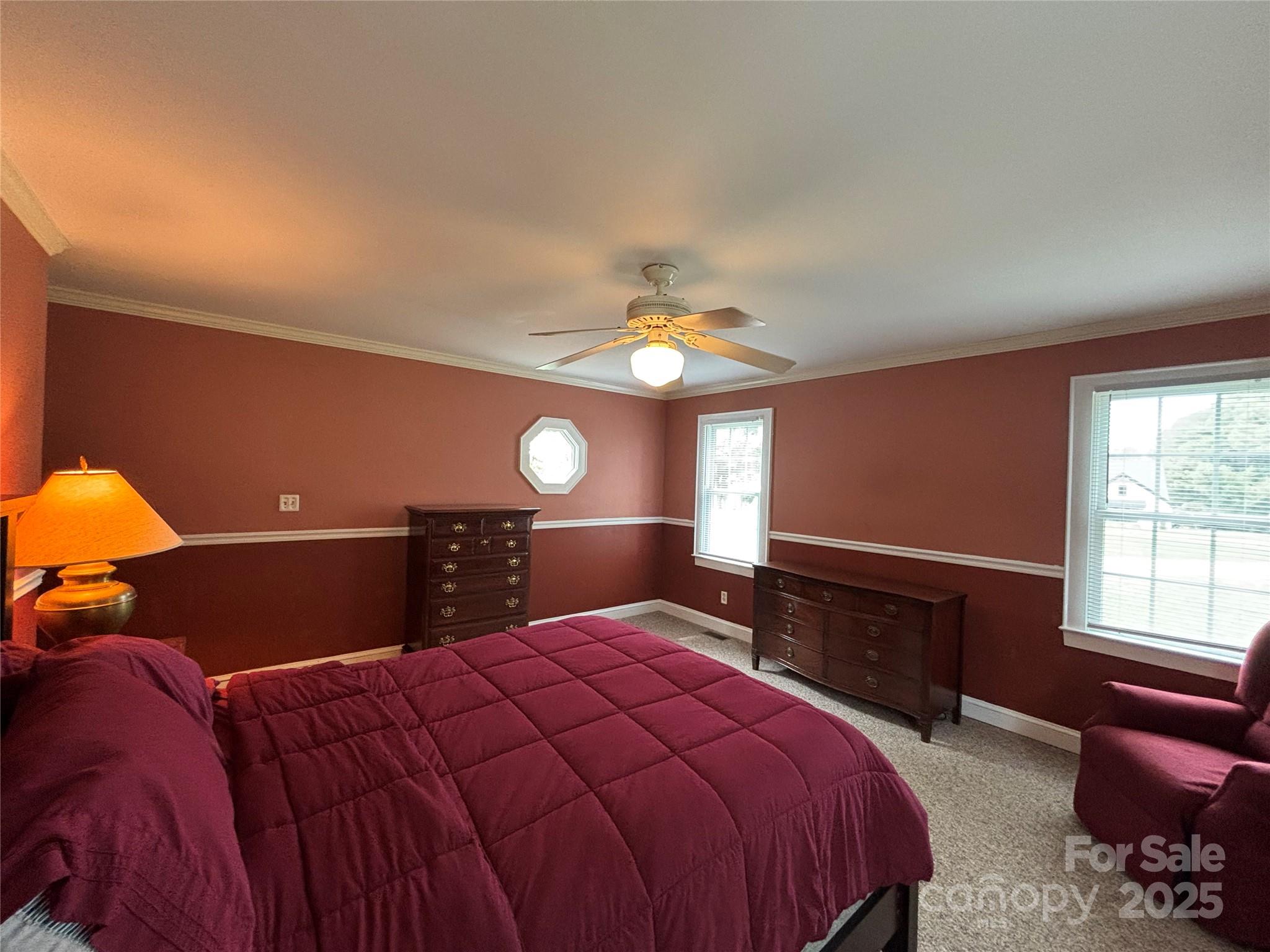 407 State Park Road Troutman, NC 28166 - Photo 18 of 21 a bedroom with a bed and a chandelier