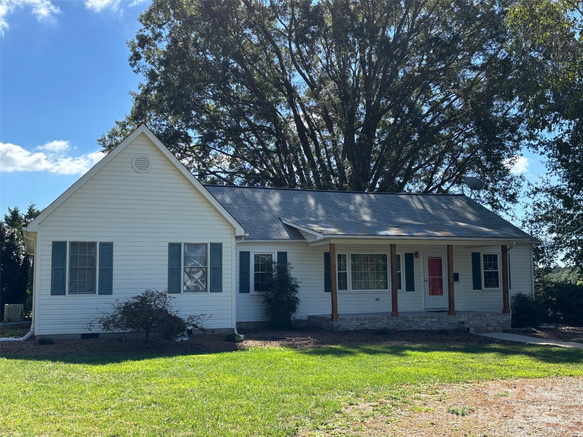 407 State Park Road Troutman, NC 28166 - Photo 6 of 21 a front view of a house with a yard and porch