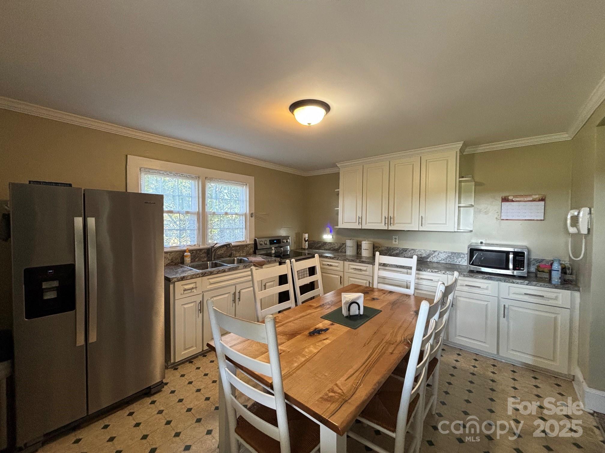 407 State Park Road Troutman, NC 28166 - Photo 9 of 21 a kitchen with kitchen island a stove a sink a refrigerator and cabinets