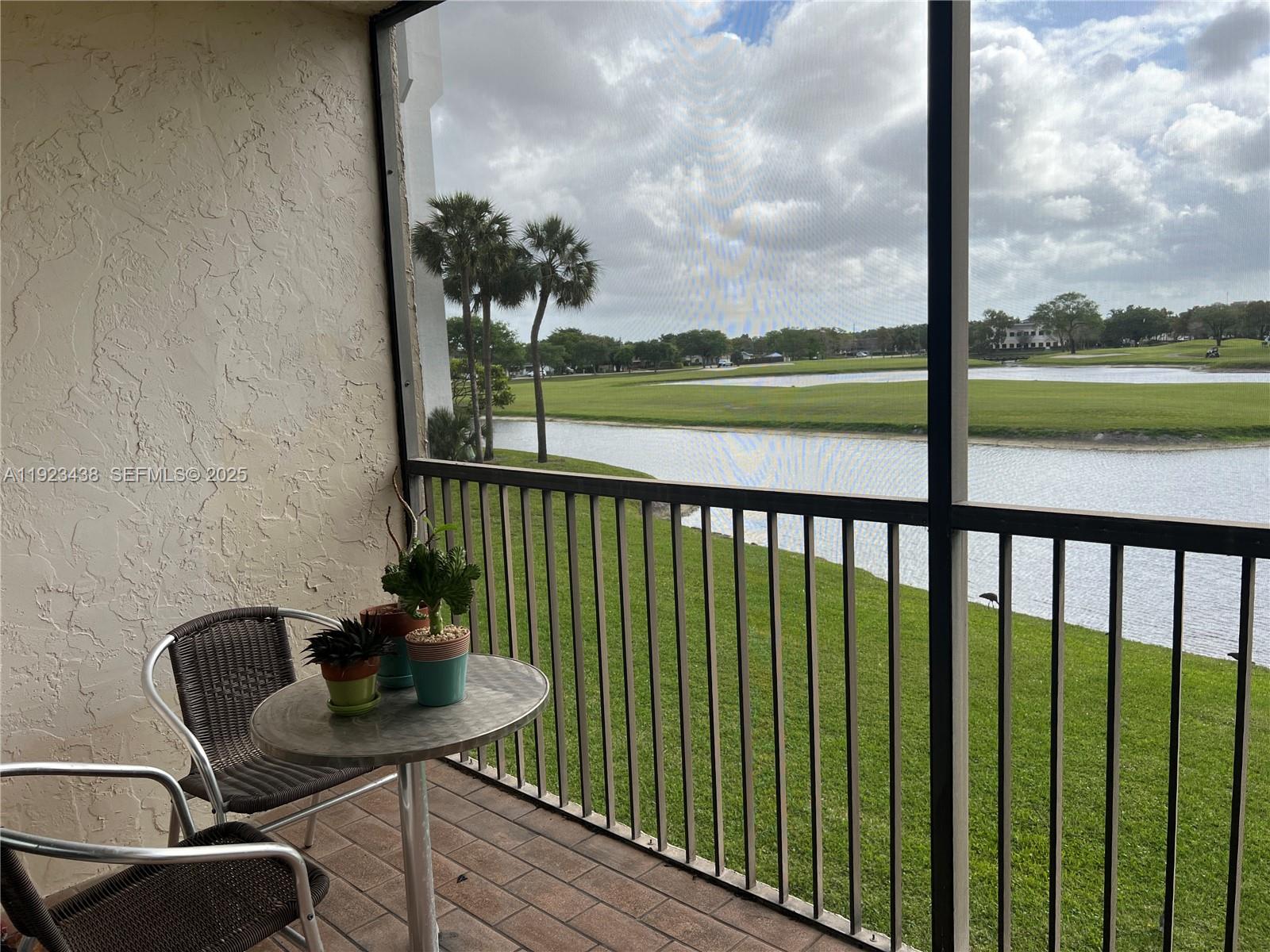a view of a balcony with chair and table