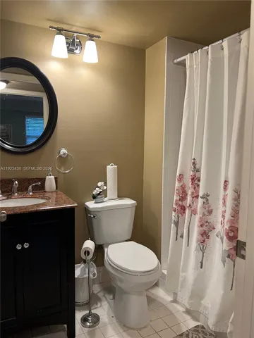 a bathroom with a toilet a sink and a mirror