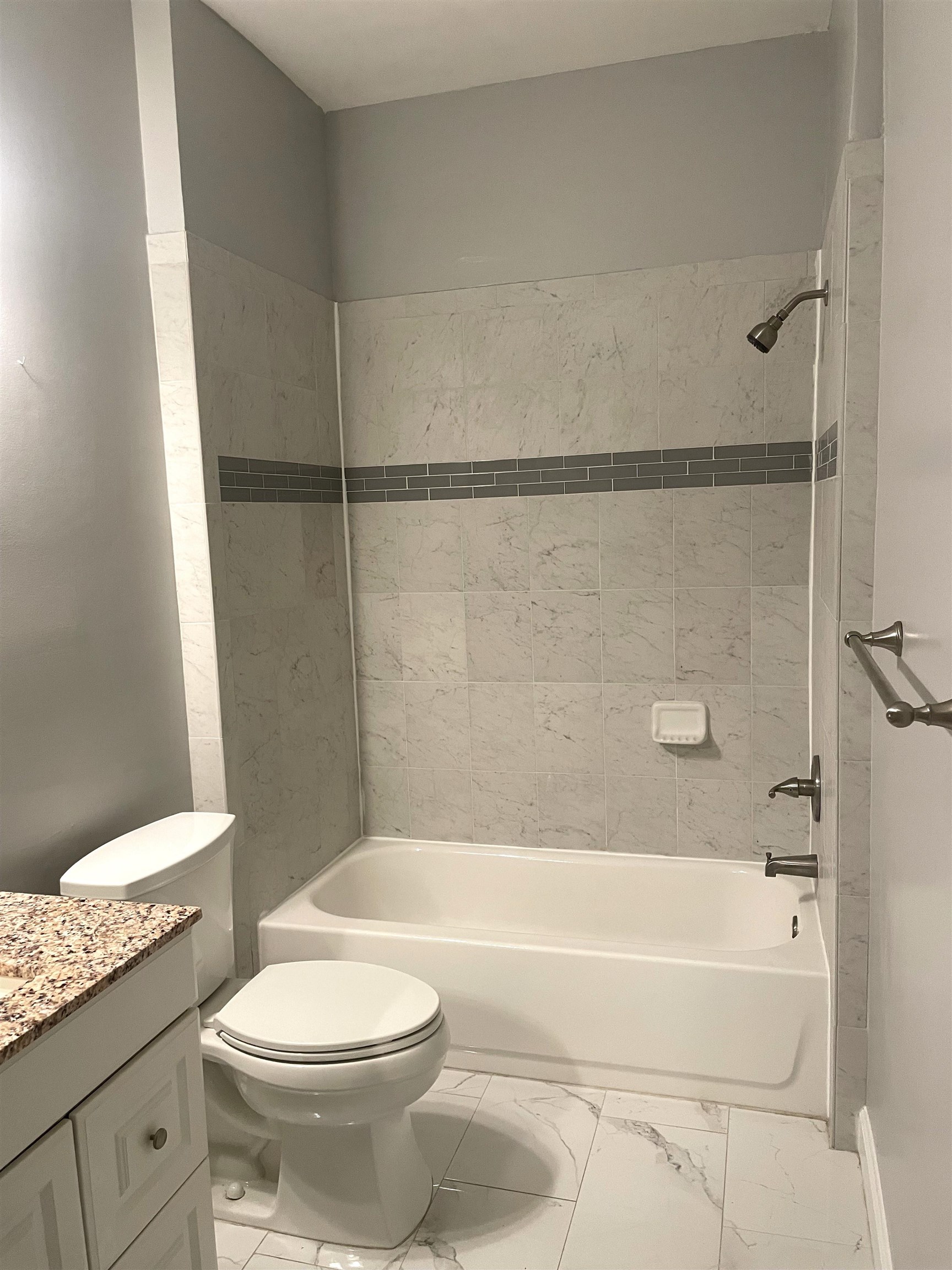 605 Fairway Drive, Unit 107 St. Augustine, FL 32084 - Photo 14 of 20 a bathroom with a granite countertop toilet a sink and bathtub