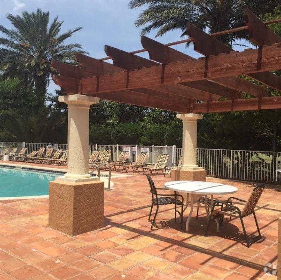 605 Fairway Drive, Unit 107 St. Augustine, FL 32084 - Photo 19 of 20 a view of a patio with a table chairs and a fire pit