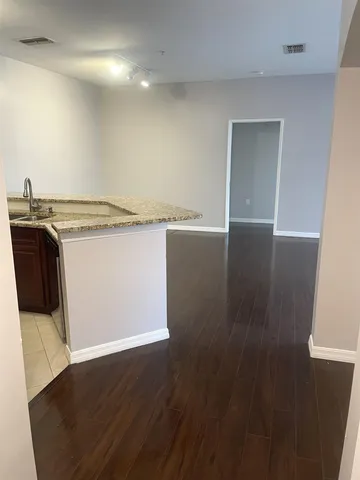 an empty room with wooden floor