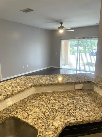 a view of a kitchen with a sink and cabinets