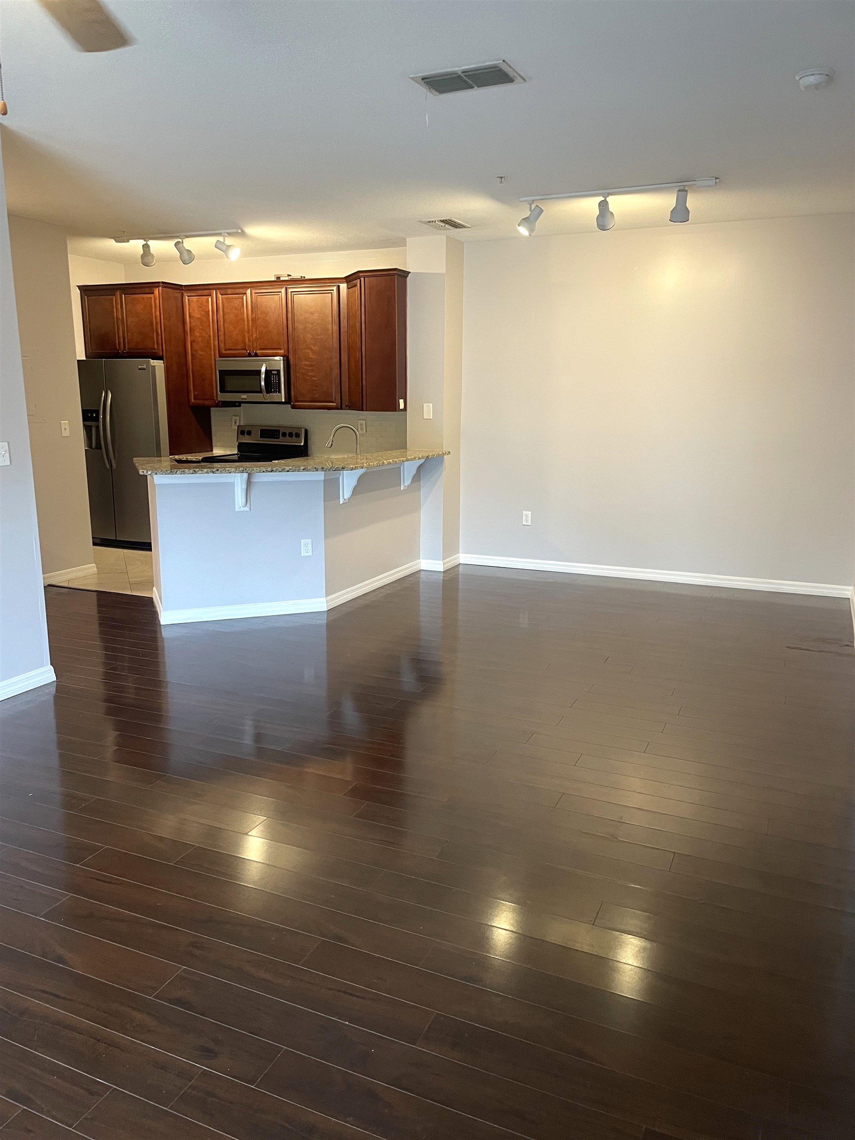 605 Fairway Drive, Unit 107 St. Augustine, FL 32084 - Photo 7 of 20 a view of a living room a kitchen and a wooden floor