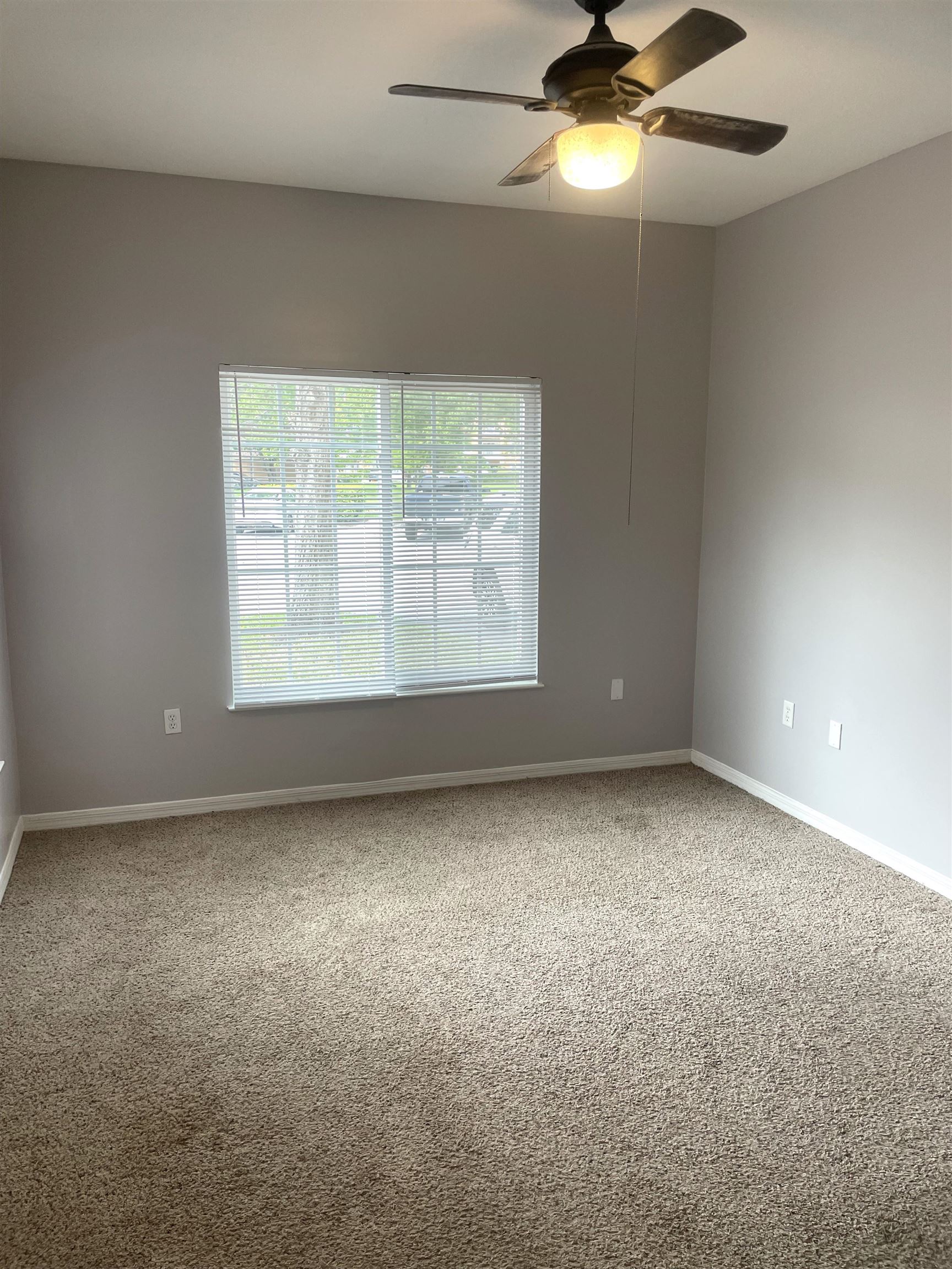 605 Fairway Drive, Unit 107 St. Augustine, FL 32084 - Photo 9 of 20 an empty room with a window and a fan