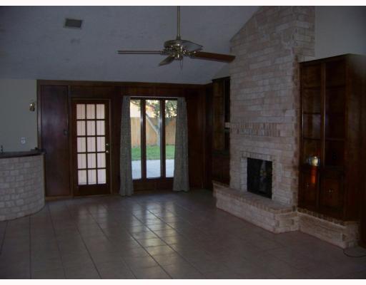 4526 Hogan Street Corpus Christi, TX 78413 - Photo 2 of 3 a view of an empty room with a fireplace and a window
