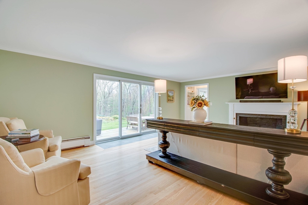 48 Miller Hill Road Dover, MA 02030 - Photo 11 of 26 a living room with furniture gym equipment and a flat screen tv