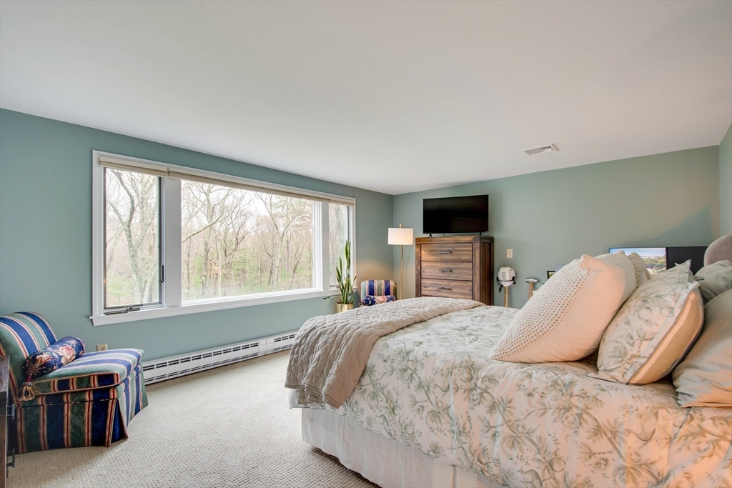 48 Miller Hill Road Dover, MA 02030 - Photo 17 of 26 a bedroom with a bed and large windows