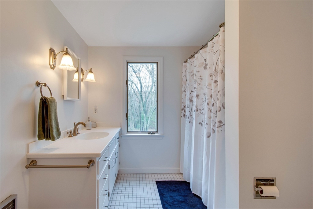 48 Miller Hill Road Dover, MA 02030 - Photo 19 of 26 a bathroom with a sink and a mirror