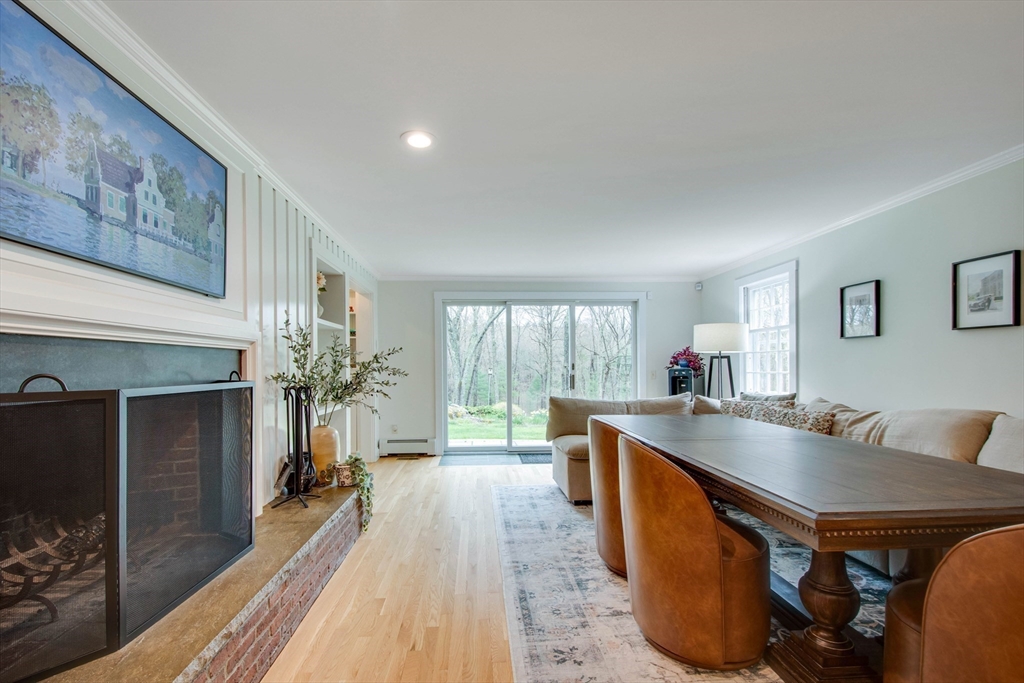 48 Miller Hill Road Dover, MA 02030 - Photo 6 of 26 a living room with furniture a large window and a fireplace