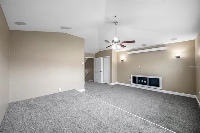 an empty room with a empty space and a ceiling fan