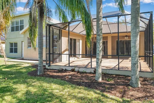 a view of a house with backyard and porch