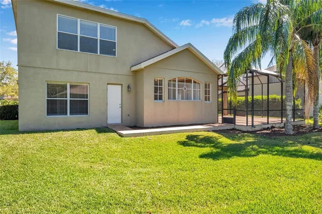 a view of house with yard and swimming pool