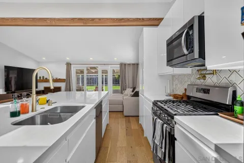 a kitchen that has a sink and a stove top oven