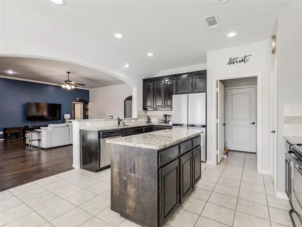 a kitchen with stainless steel appliances granite countertop a stove and a sink