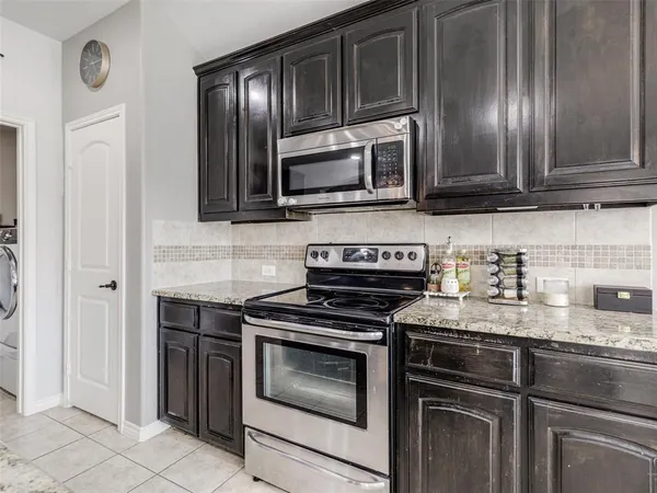 a kitchen with granite countertop stainless steel appliances and cabinets