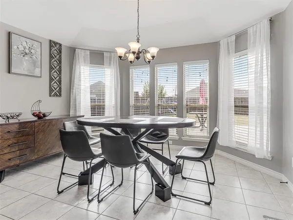 a dining room that has a dining table and a chandelier