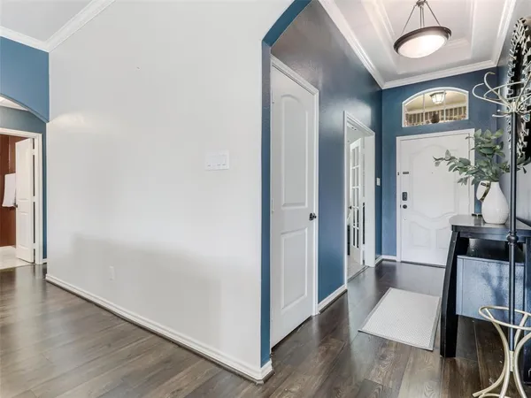 a view of hallway with furniture and wooden floor