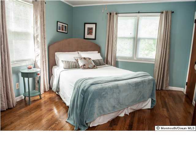 280 Sudbury Road Point Pleasant, NJ 08742 - Photo 11 of 20 a bedroom with a bed and wooden floor