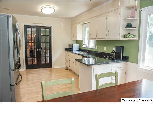 280 Sudbury Road Point Pleasant, NJ 08742 - Photo 3 of 20 a kitchen with stainless steel appliances granite countertop a stove a refrigerator and a sink