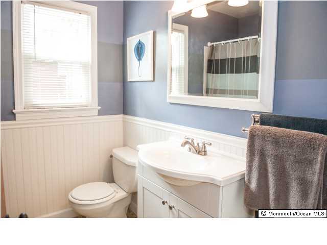 280 Sudbury Road Point Pleasant, NJ 08742 - Photo 10 of 20 a bathroom with a sink toilet and mirror