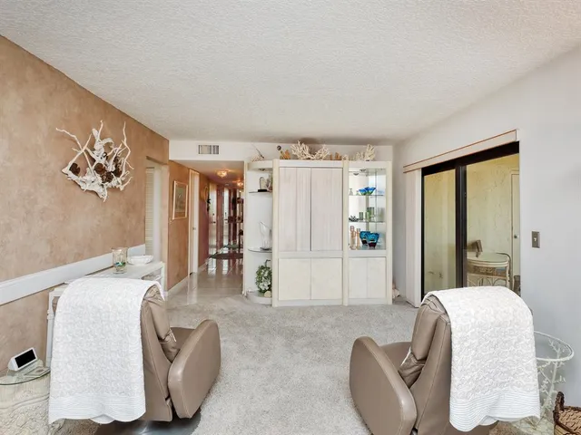 a balcony with table and chairs