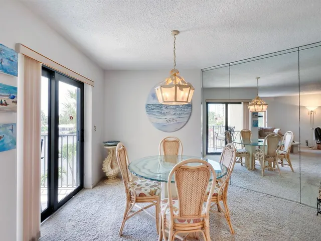 a view of a hallway with furniture and a window