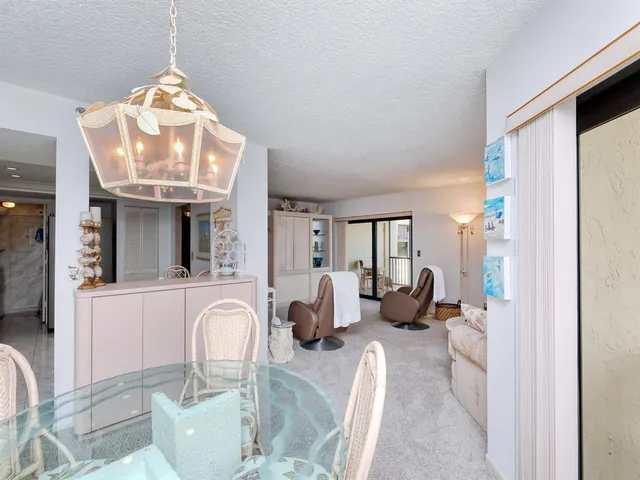 a balcony with table and chairs