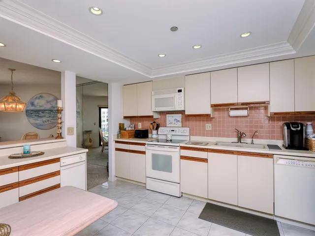 a bathroom with a granite countertop sink a mirror and shower