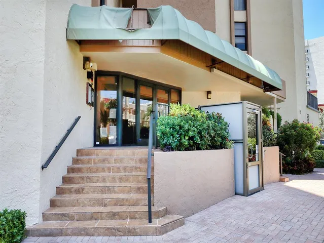 a sign that is sitting in front of flowers