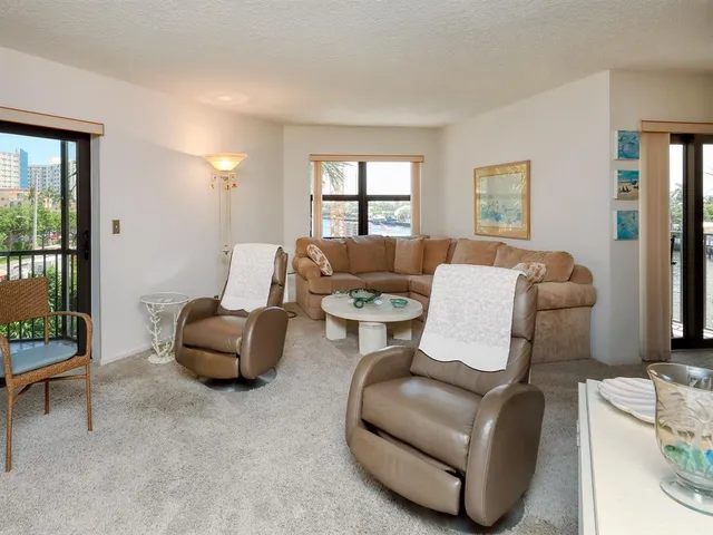 a dining room with furniture a chandelier and window