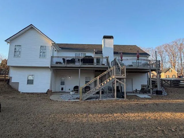 a view of a house with a wooden deck