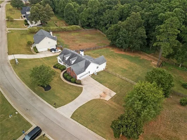 an aerial view of a house with a yard