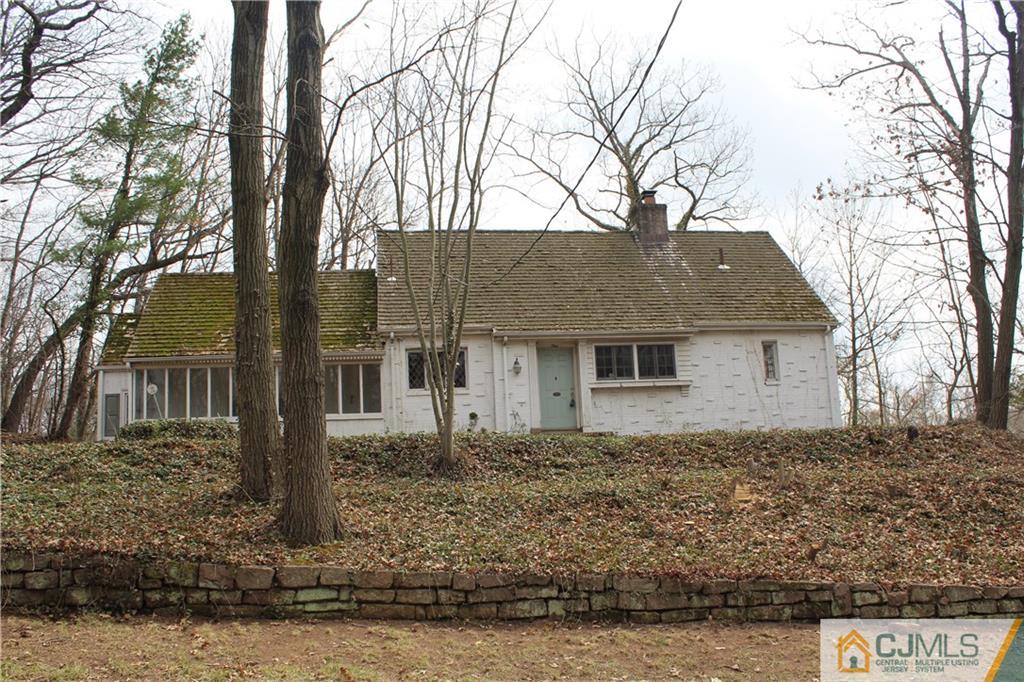 1 Edgebrook Road New Brunswick, NJ 08901 - Photo 1 of 8 a house that has a tree in front of it