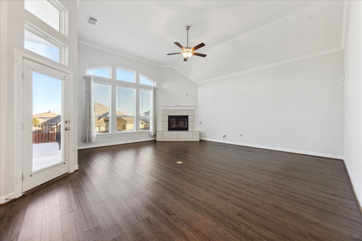 623 Baretta Loop Buda, TX 78610 - Photo 2 of 10 a view of a livingroom with wooden floor and a ceiling fan