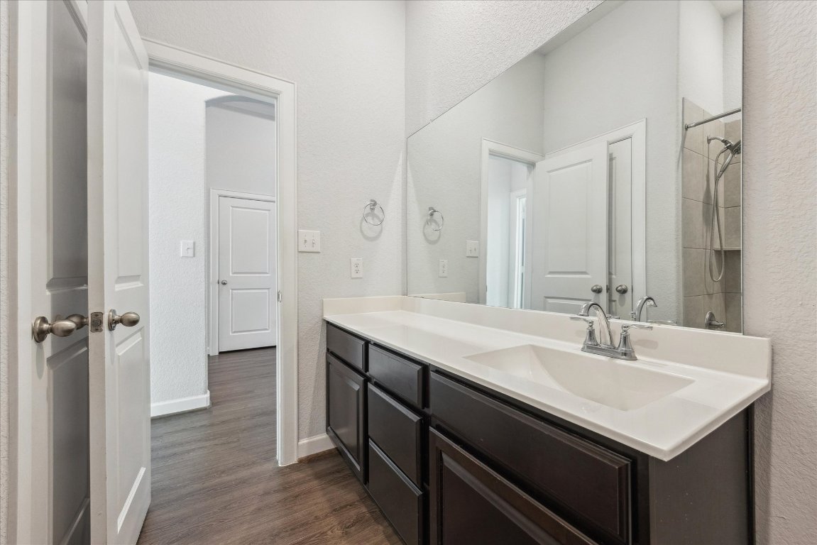 623 Baretta Loop Buda, TX 78610 - Photo 9 of 10 a bathroom with a sink and a mirror