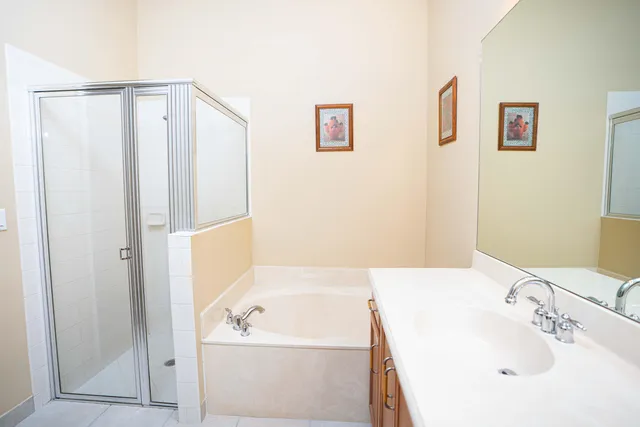 a bathroom with a tub a sink and a mirror