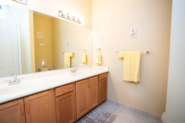 a bathroom with a double vanity sink and a mirror