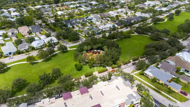 an aerial view of a residential houses with yard